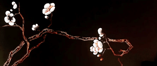Heritage lacquer art depicting delicate plum blossoms in Chinese style