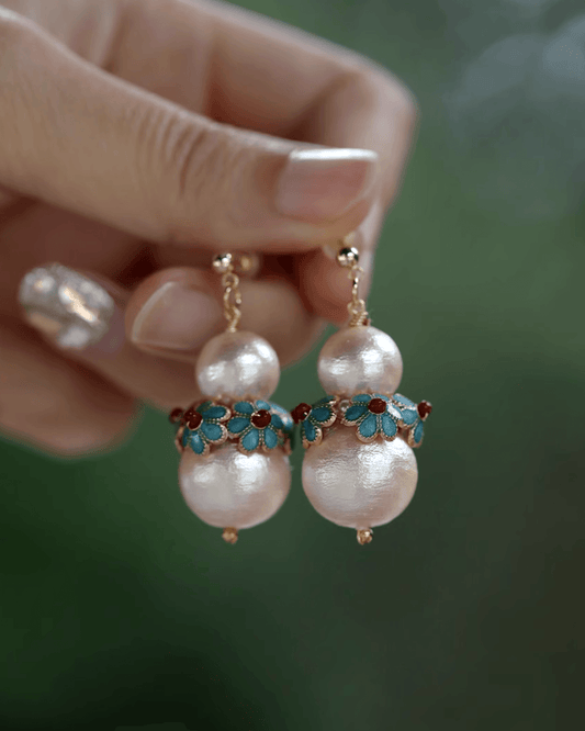 close-up of enamel and filigree detailing on handcrafted earrings