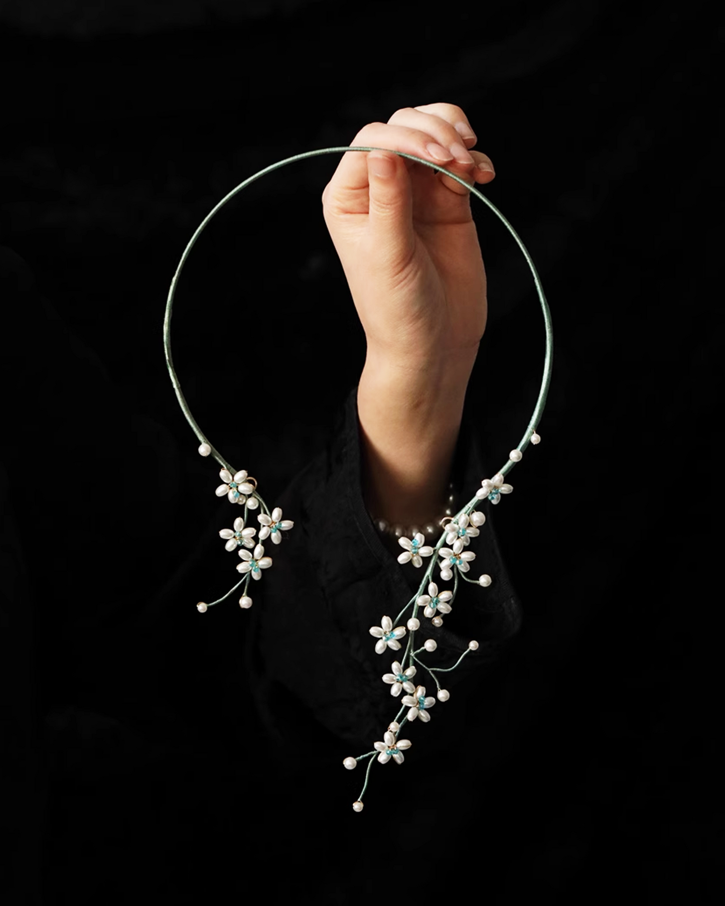 Flat lay of pearl choker inspired by Song Dynasty floral scrolls, featuring handpicked shell pearls and silver accents