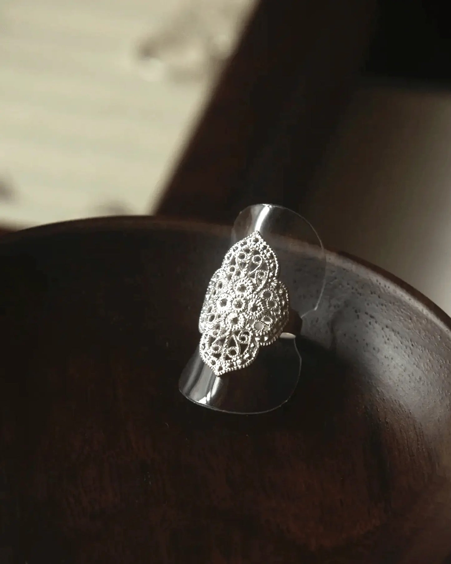 Close-up of hand-chiseled geometric openwork on 2.5 mm sterling silver band, echoing traditional Liangshan Yi motifs