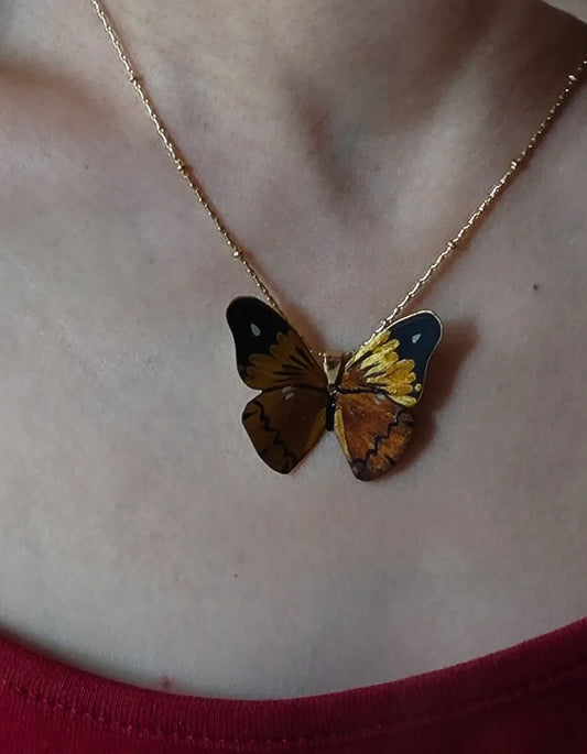 Elegant Model Wearing Black Gold Butterfly Lacquer Necklace with Dress