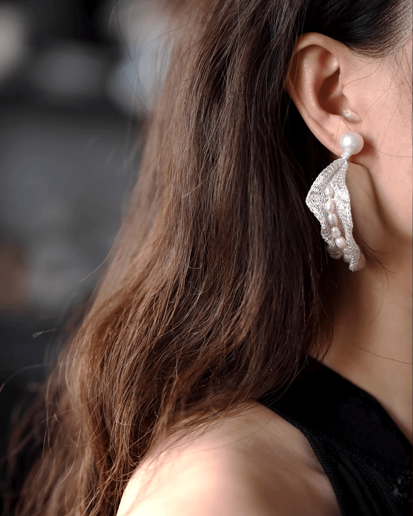 Side profile showing earrings’ feather-light presence and subtle shimmer alongside minimalist hairstyle