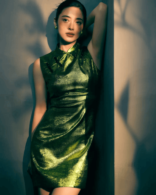 Flat lay of green Mabe pearl earrings in 18K gold prong setting, inspired by Eastern cosmology of round heaven and square earth