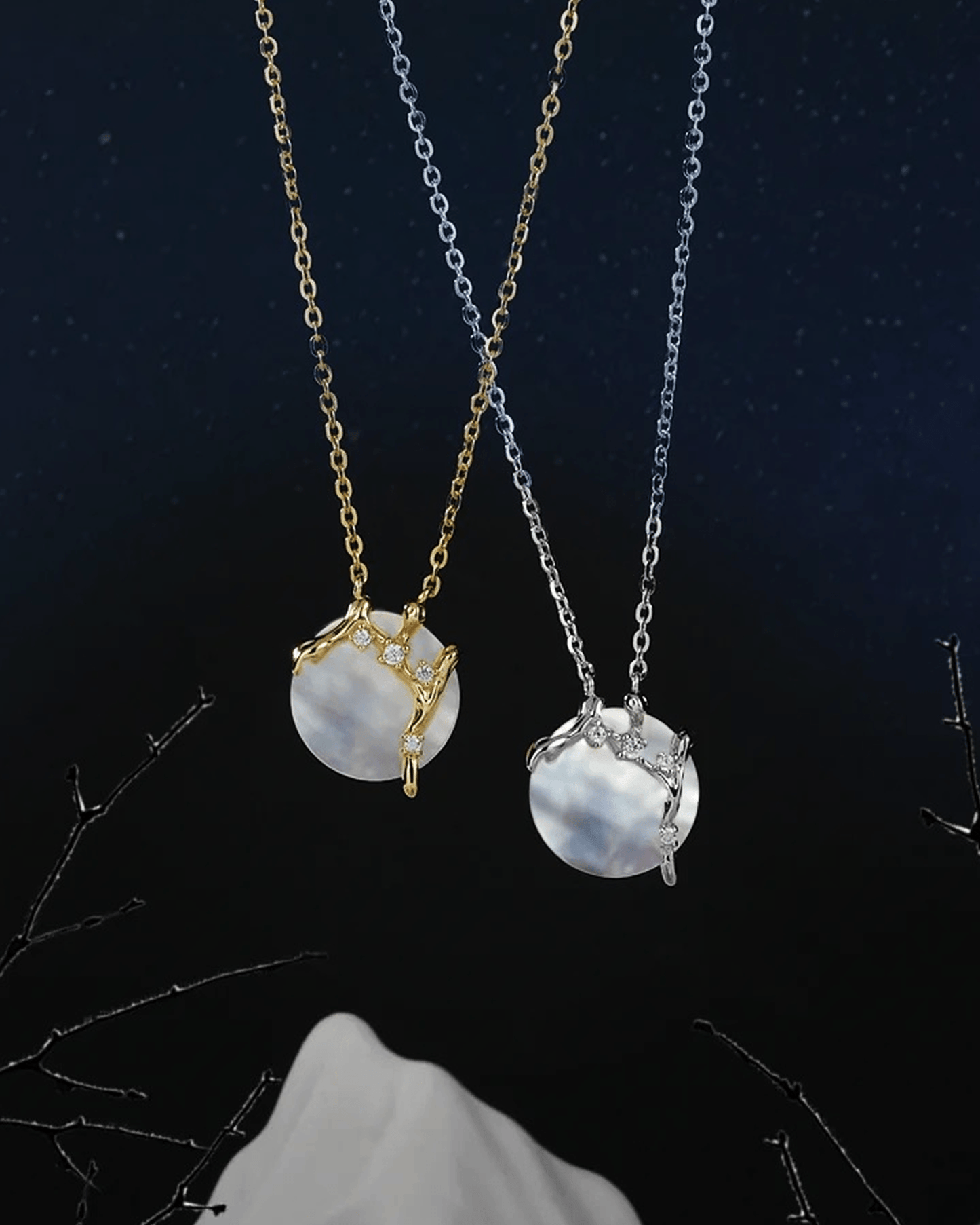 Close-up of iridescent 8mm mother-of-pearl moon pendant glowing softly against textured silver branches