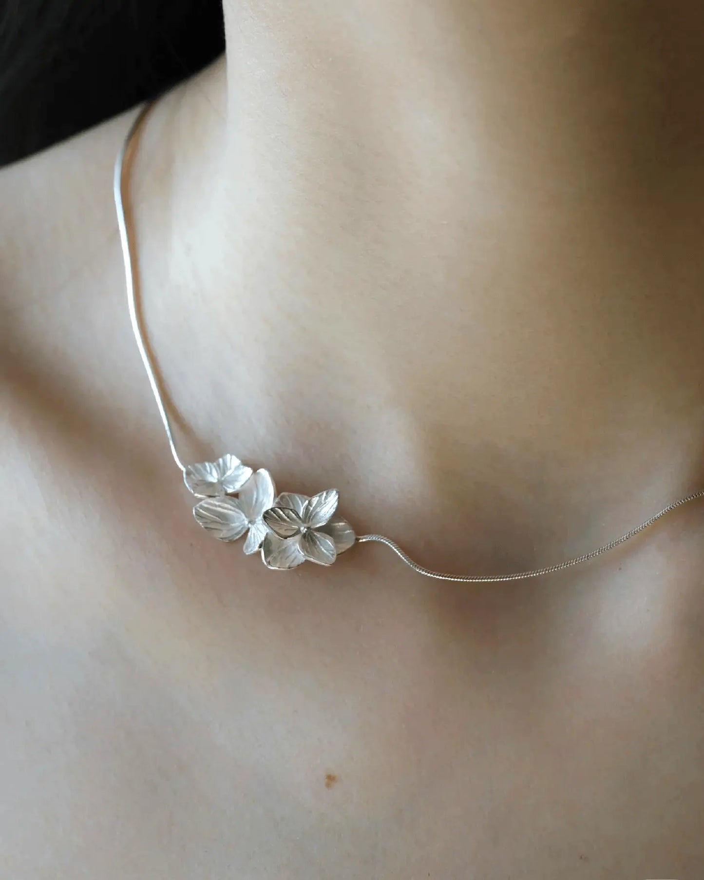 Close-up of clustered silver petals hand-polished to reflect natural hydrangea textures and tones