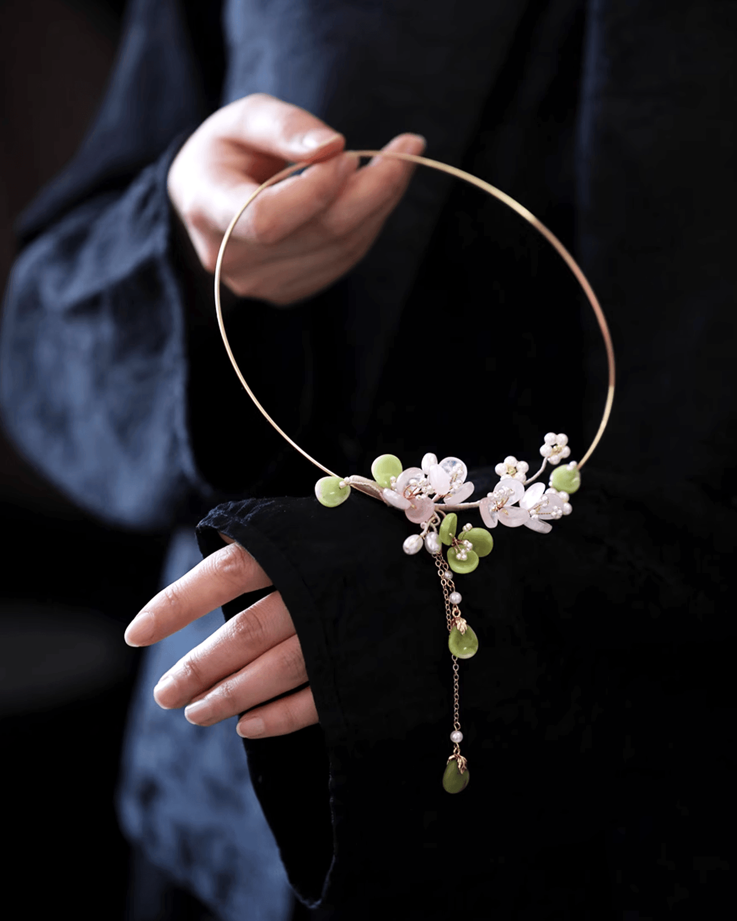Flat lay of rose quartz choker with silver plum blossom pendant, showcasing delicate oriental design and gemstone clarity