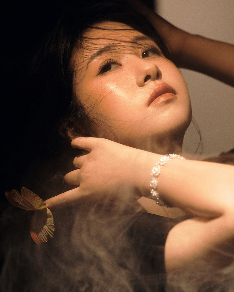 Asian model styling double-layer lotus filigree silver bracelet with traditional-inspired outfit