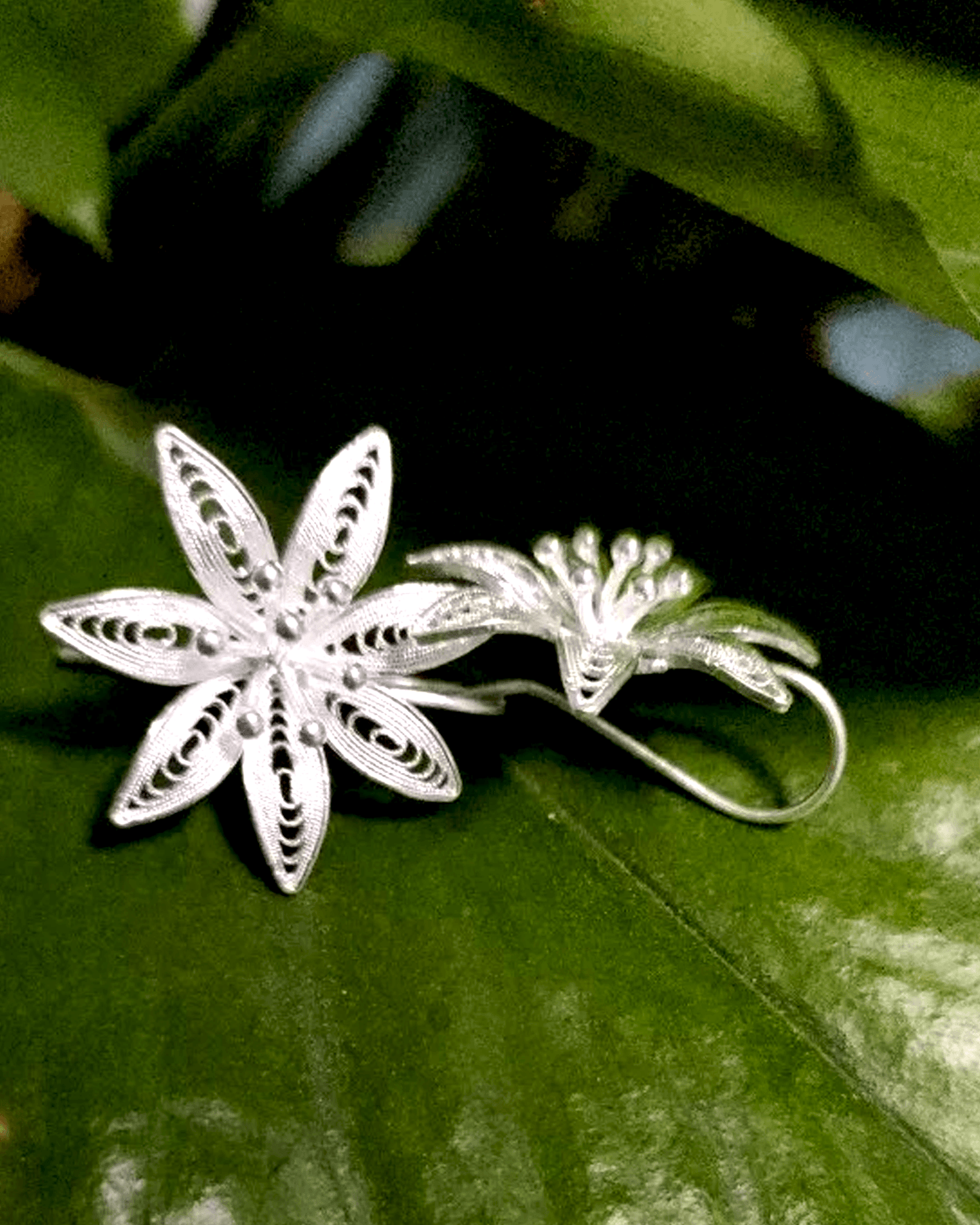 Side view of Celestial Petals earrings with S-curve ergonomic hooks and open-petal structure