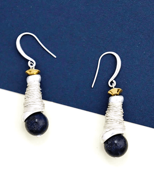 Detail of natural lapis lazuli stone glowing with deep celestial blue, set within hand-crafted silver spiral