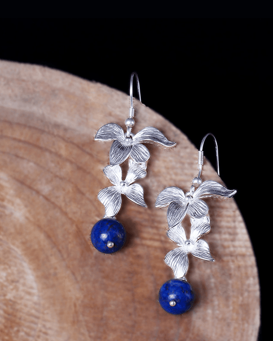 Detail shot showing 2.7-inch elegant drape and feather-light design of celestial orchid earrings