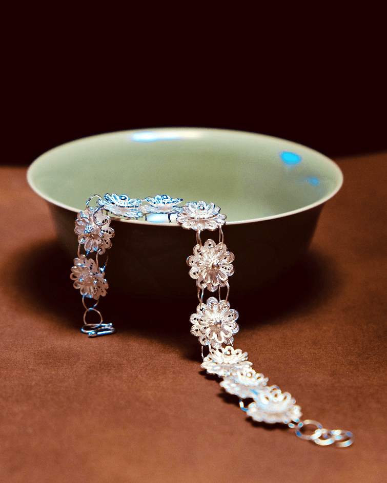 Detail view of double-layer lotus petals and silver vine design on Chinese filigree bracelet
