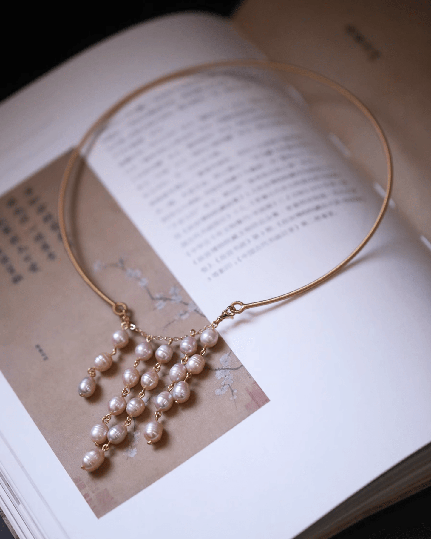 Close-up of hand-picked blush pearls with high luster and soft rosé overtones on tassel earrings