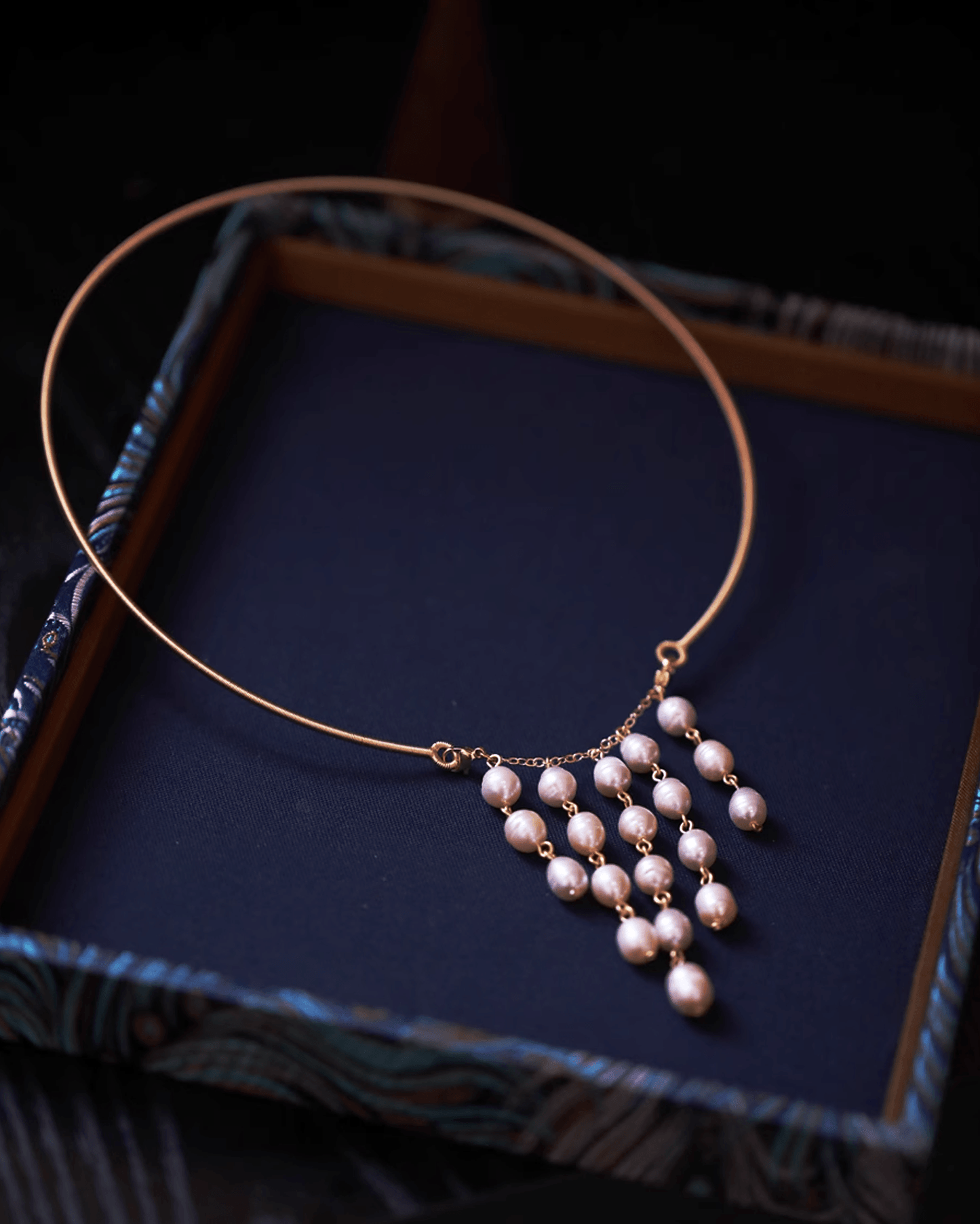 Wedding flat lay with pearl earrings, embroidered qipao fabric and red envelope, perfect for bridal heirloom styling