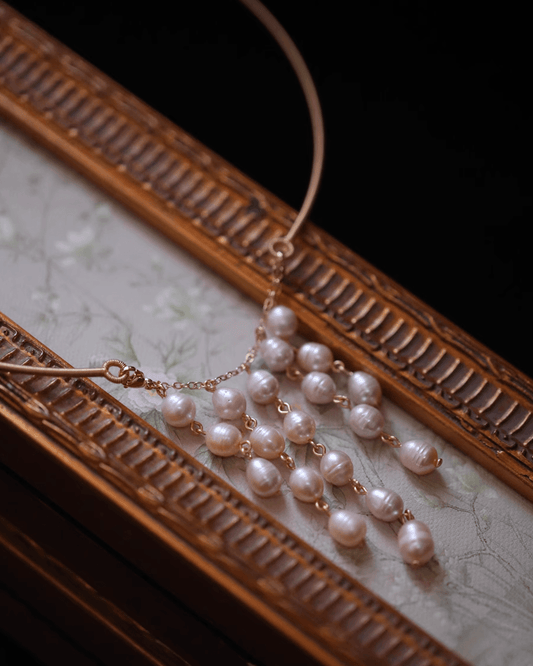 Elegant gift box with blush pearl tassel earrings and wild orchid sprig, suitable for meaningful cultural gifts