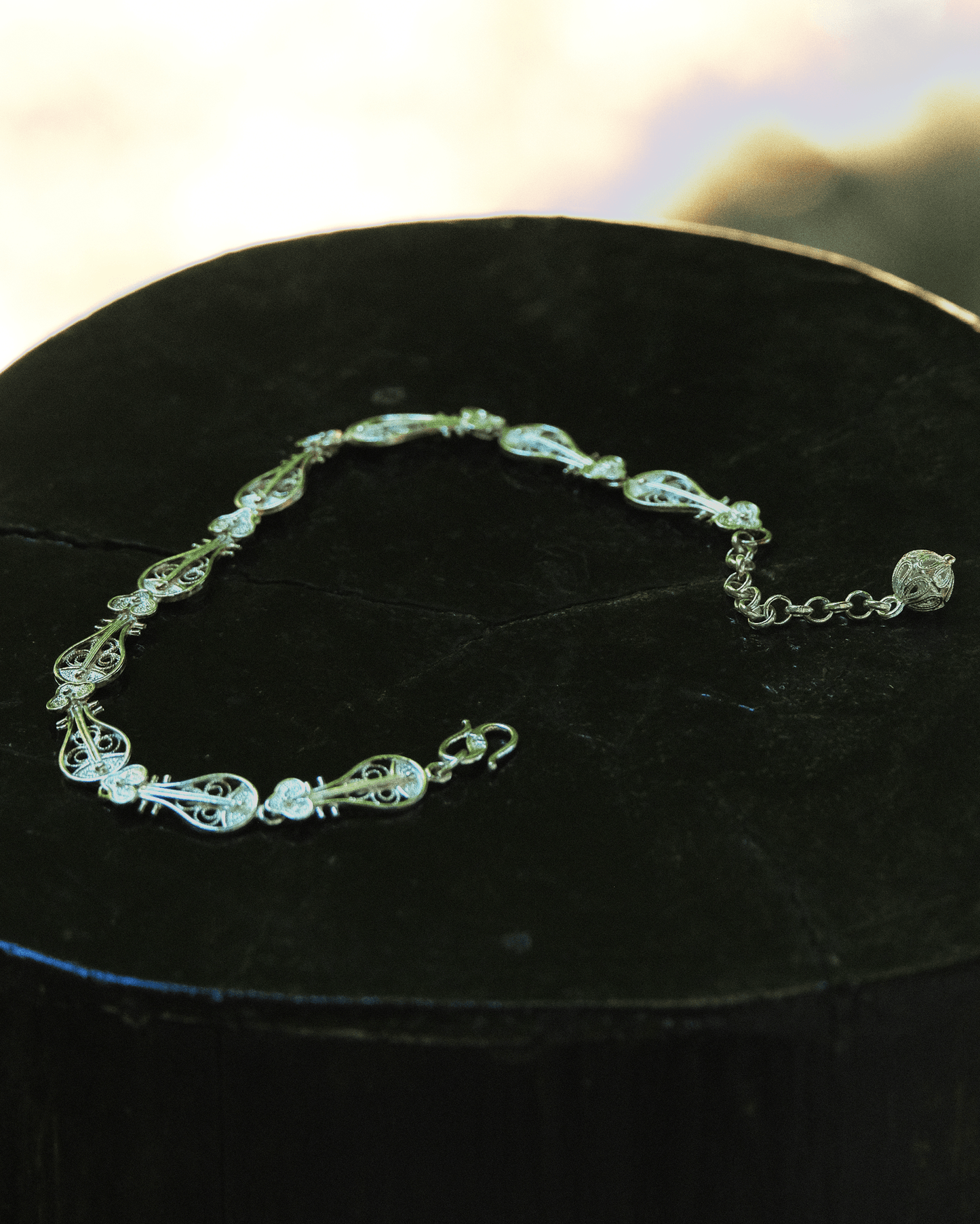 Close-up of handcrafted Pipa-shaped silver bracelet with fine Chinese filigree wirework