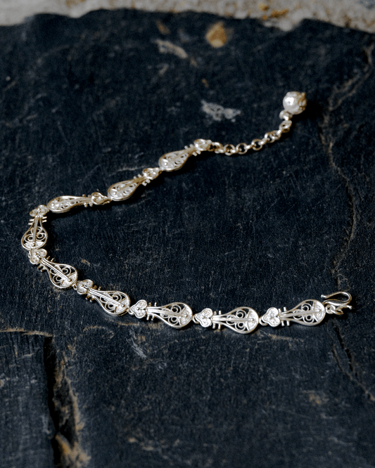 Detailed view of Pipa Song bracelet showing silver filigree and delicate chain links