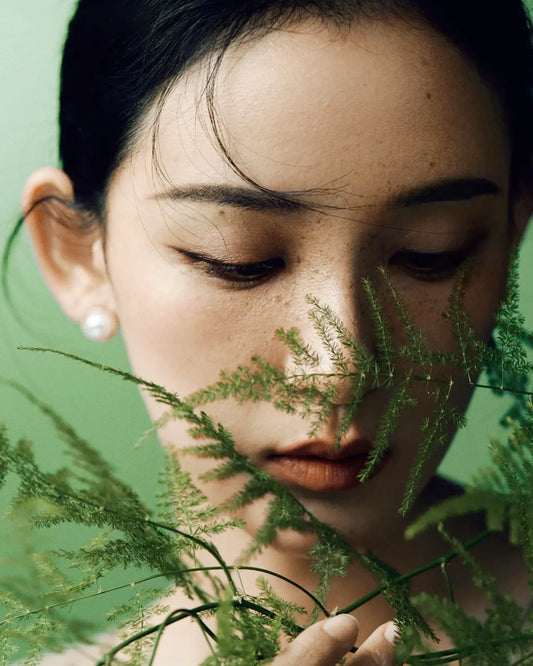 Model wearing 12mm pearl studs with soft silk blouse, reflecting timeless elegance and calm