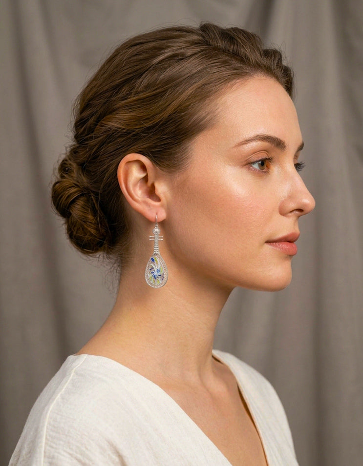 A women wearing zolanjewelry 999 fine silver pipa earrings feature imperial Huasi Xiangqian and Cloisonné Enamel