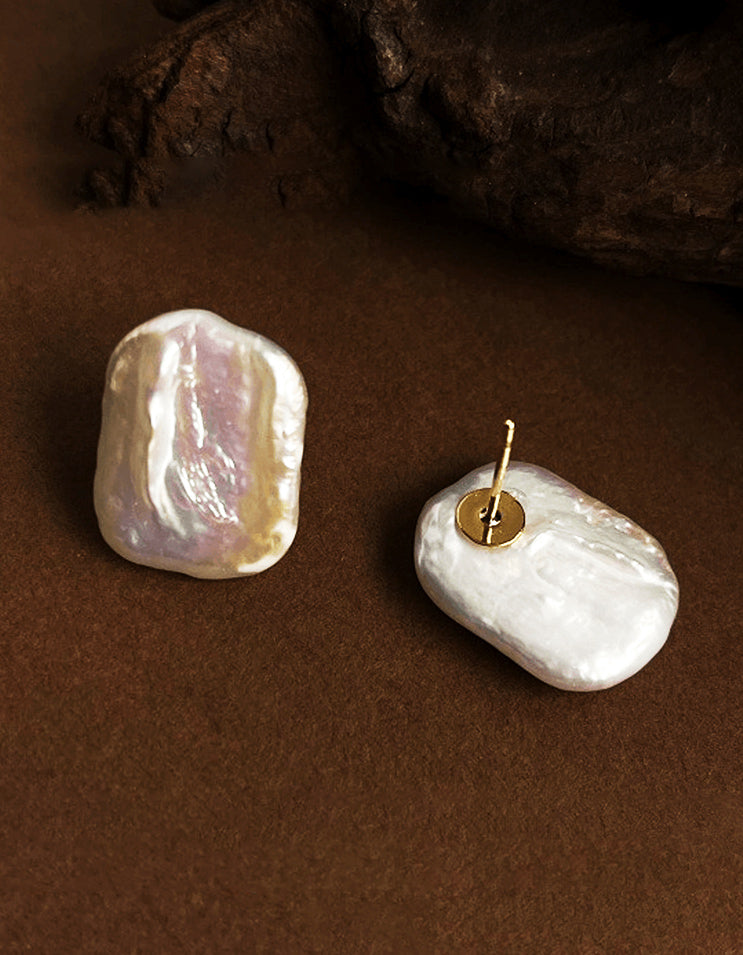 Nature defies symmetry. These Baroque Lumina studs cradle luminous, one-of-a-kind pearls in modern matte silver bezels.