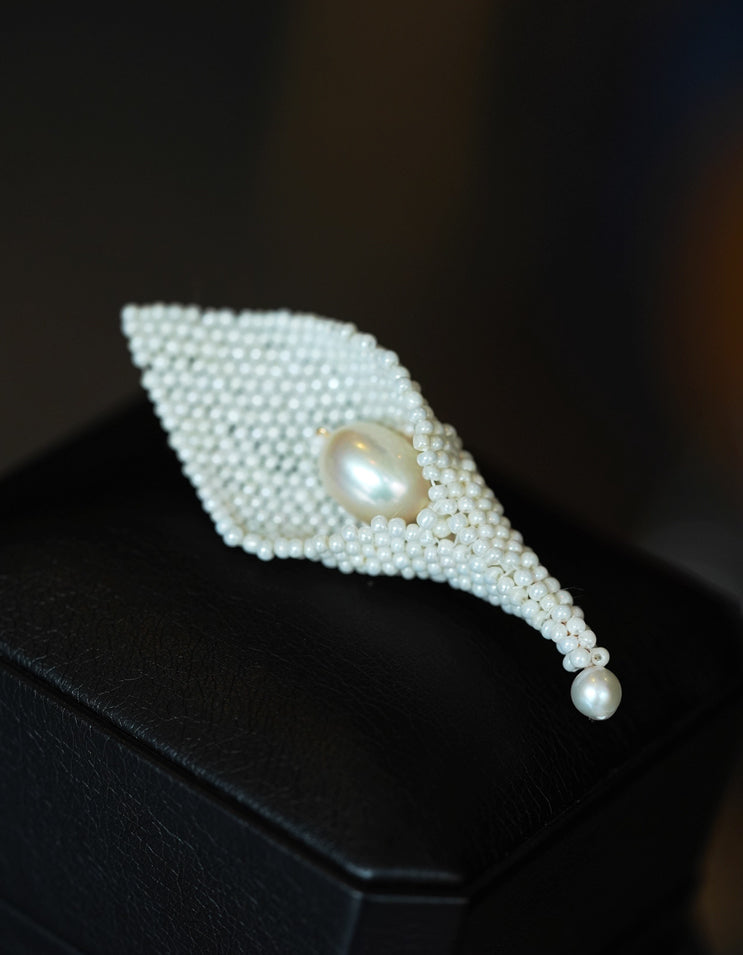Detailed view of ZolanJewelry Calla Lily brooch featuring natural pearl and silver filigree craftsmanship.