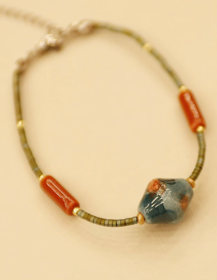 Close-up of ceramic bead bracelet from ZolanJewelry new collection, inspired by traditional Chinese aesthetics and handcrafted jewelry design.