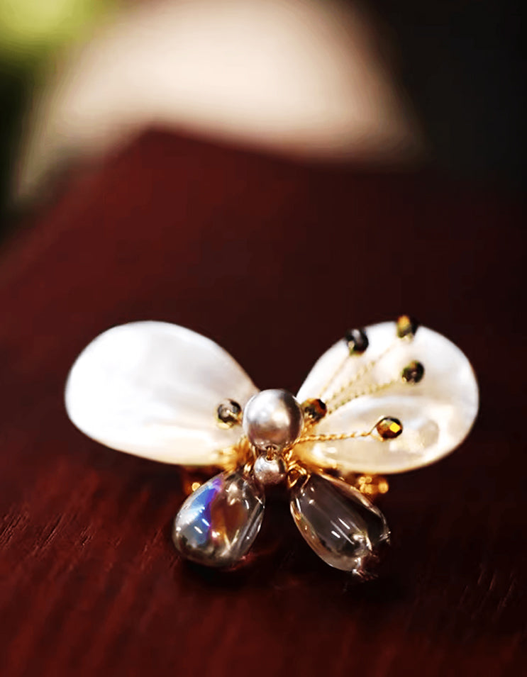 Close-up of handcrafted Chinese butterfly brooch pin carved from iridescent abalone shell