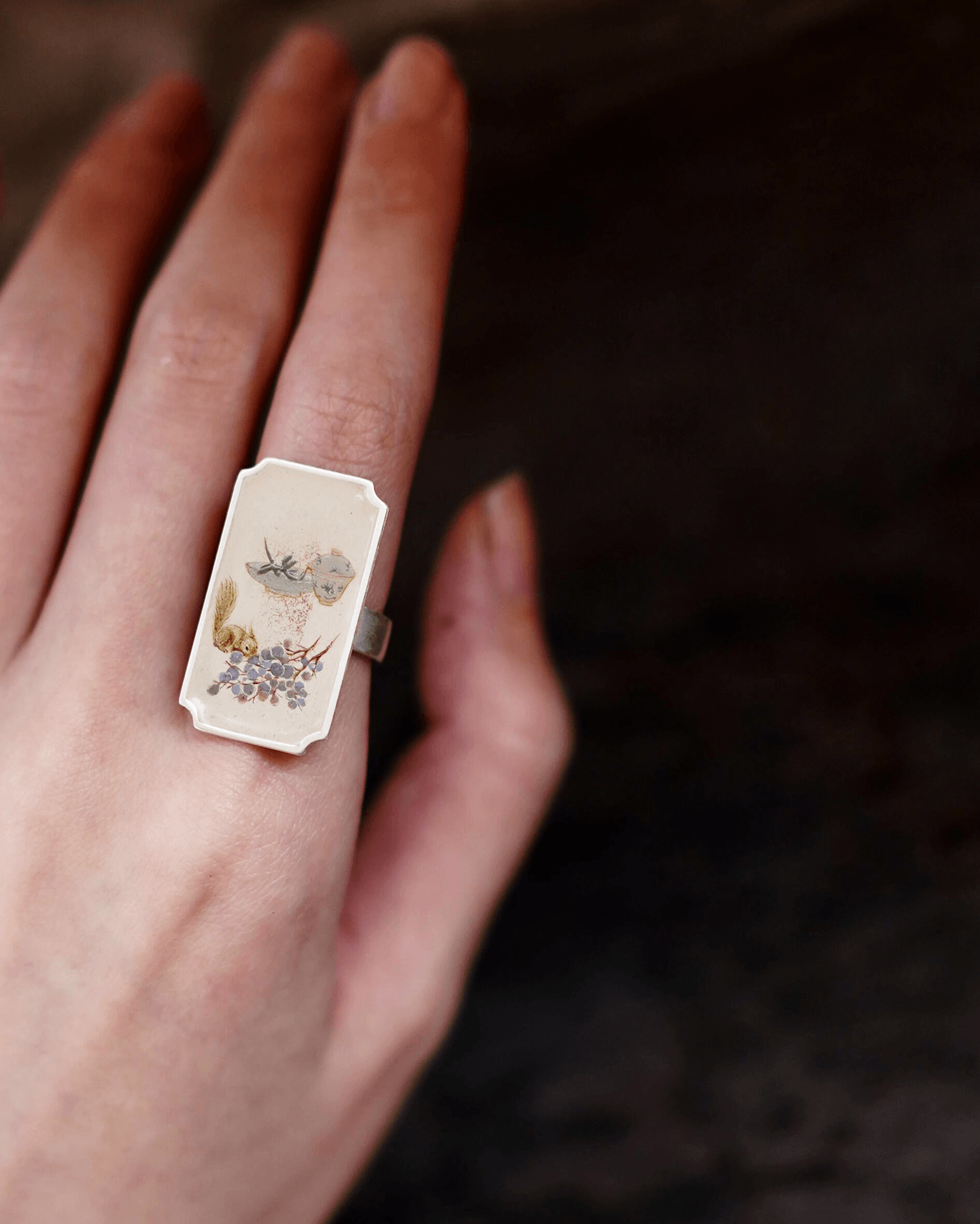 Asian model wearing hand-painted Chinese lacquer ring inspired by traditional paintings