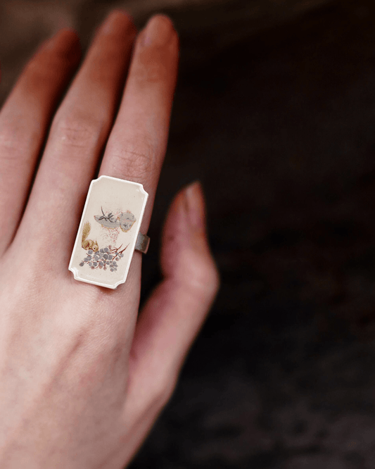 Asian model wearing hand-painted Chinese lacquer ring inspired by traditional paintings
