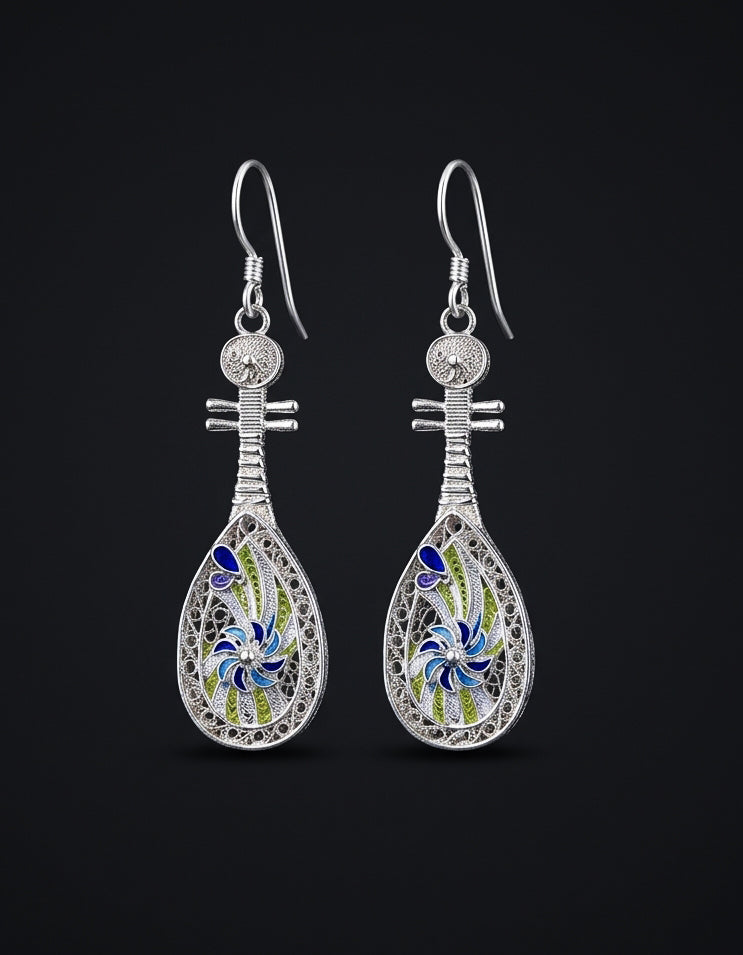 Inspired by Dunhuang's flying apsaras, these 999 fine silver pipa earrings feature imperial Huasi Xiangqian and Cloisonné Enamel. Elegant Chinese filigree art.