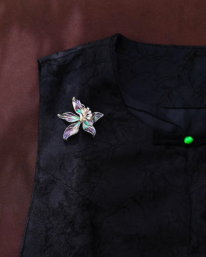 Flat lay of iris enamel brooch in cloisonné technique, inspired by Chinese ink-wash paintings and spring blossoms