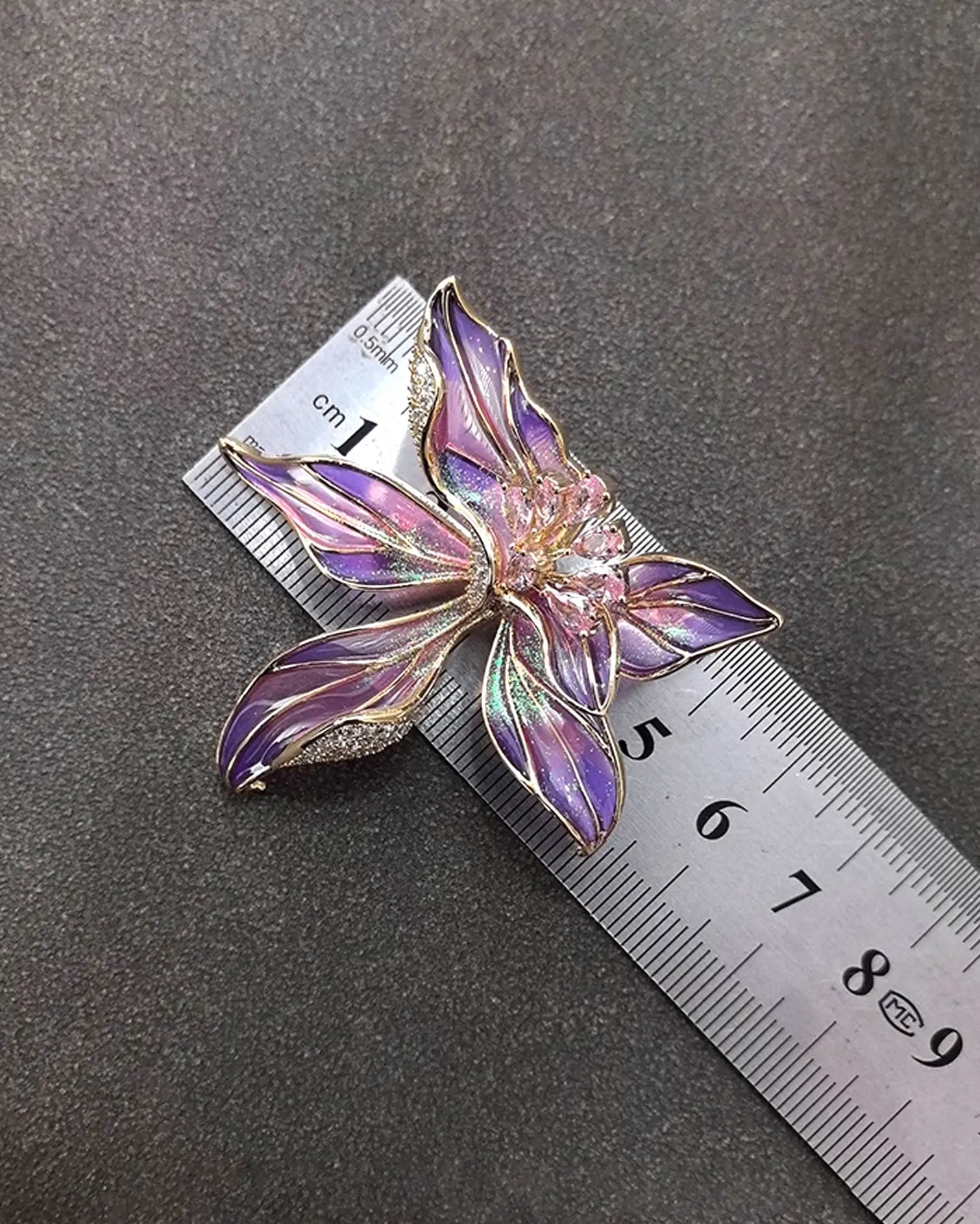 Close-up of hand-fired enamel petals with vibrant blue and purple strokes, resembling watercolor brushwork