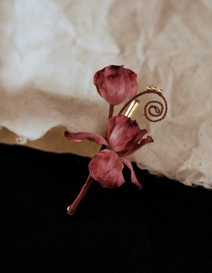 Close-up of pink velvet flower brooch showing fine hand-shaped silk petals