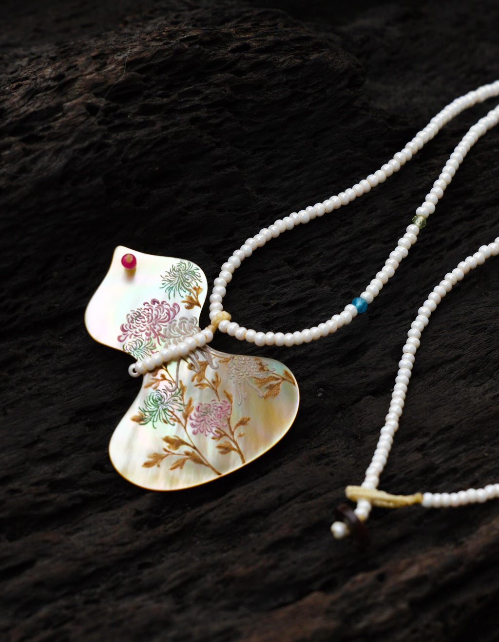 Fortune in Bloom Chinese lacquer necklace featuring a gourd-shaped yellow mother-of-pearl pendant hand-painted with chrysanthemum flowers.