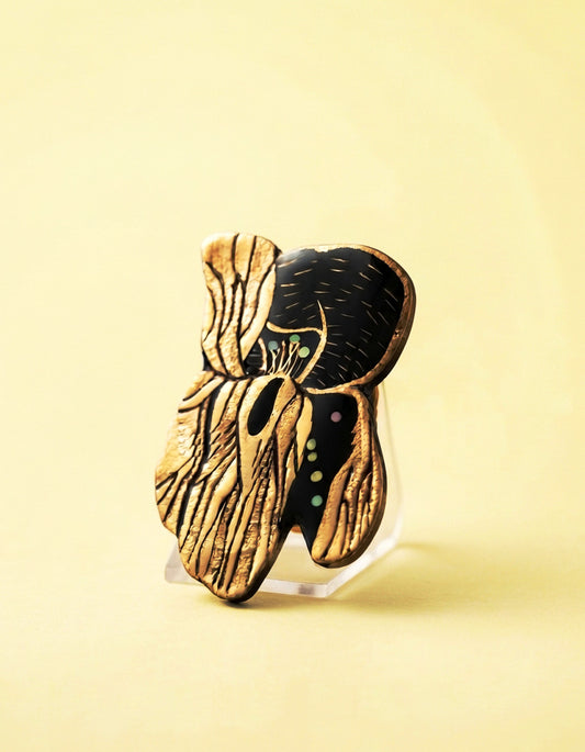 Close-up of a handcrafted Chinese lacquer iris brooch by ZolanJewelry, featuring natural lacquer, mother-of-pearl inlay, and fine gilded detailing.