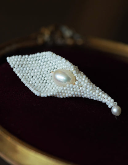 Close-up of ZolanJewelry Calla Lily brooch showing the smooth natural pearl and fine filigree texture.