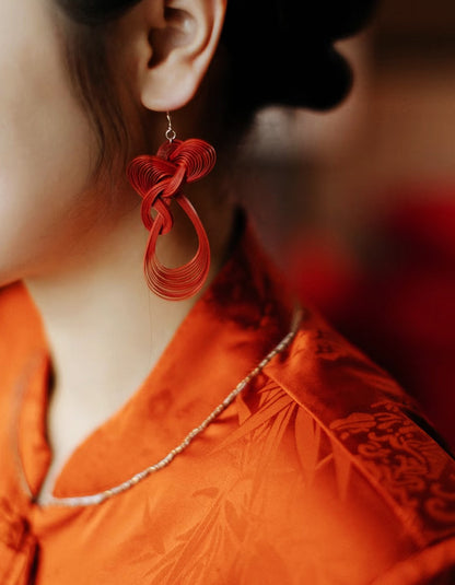 Lifestyle shot of bamboo weave earrings styled with elegant outfit