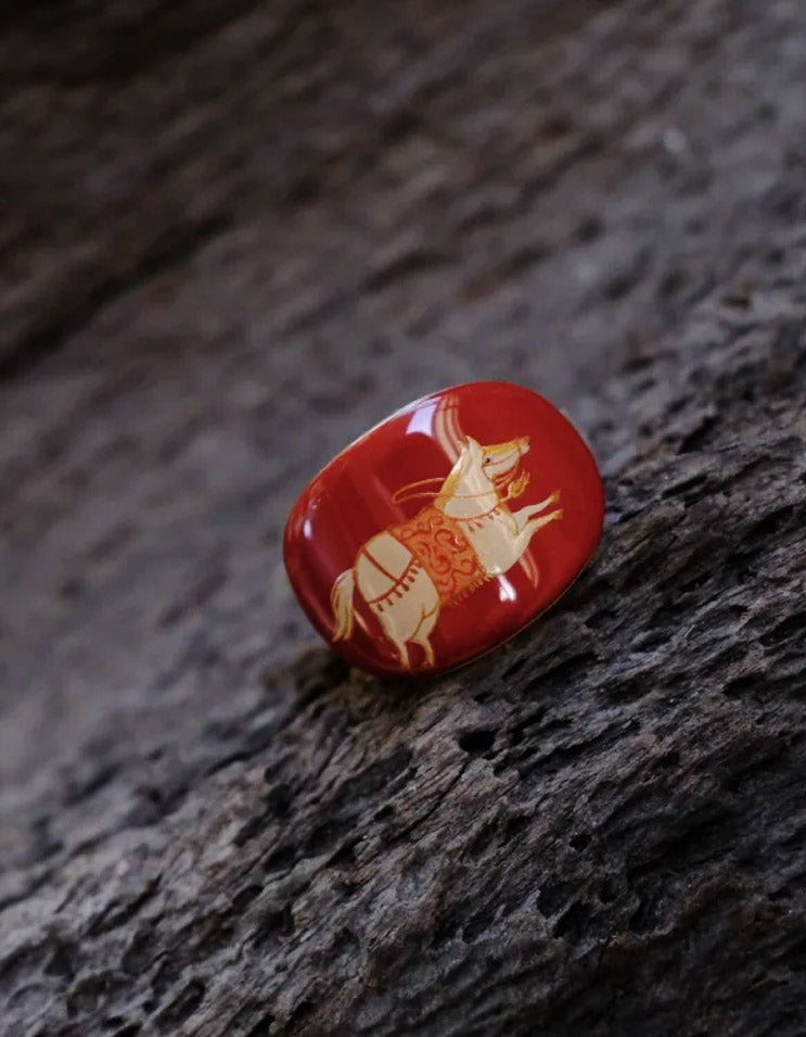 Close-up of the Red-Gold Maned Horse lacquer ring, showcasing handcrafted Chinese lacquer craftsmanship and red-gold tones