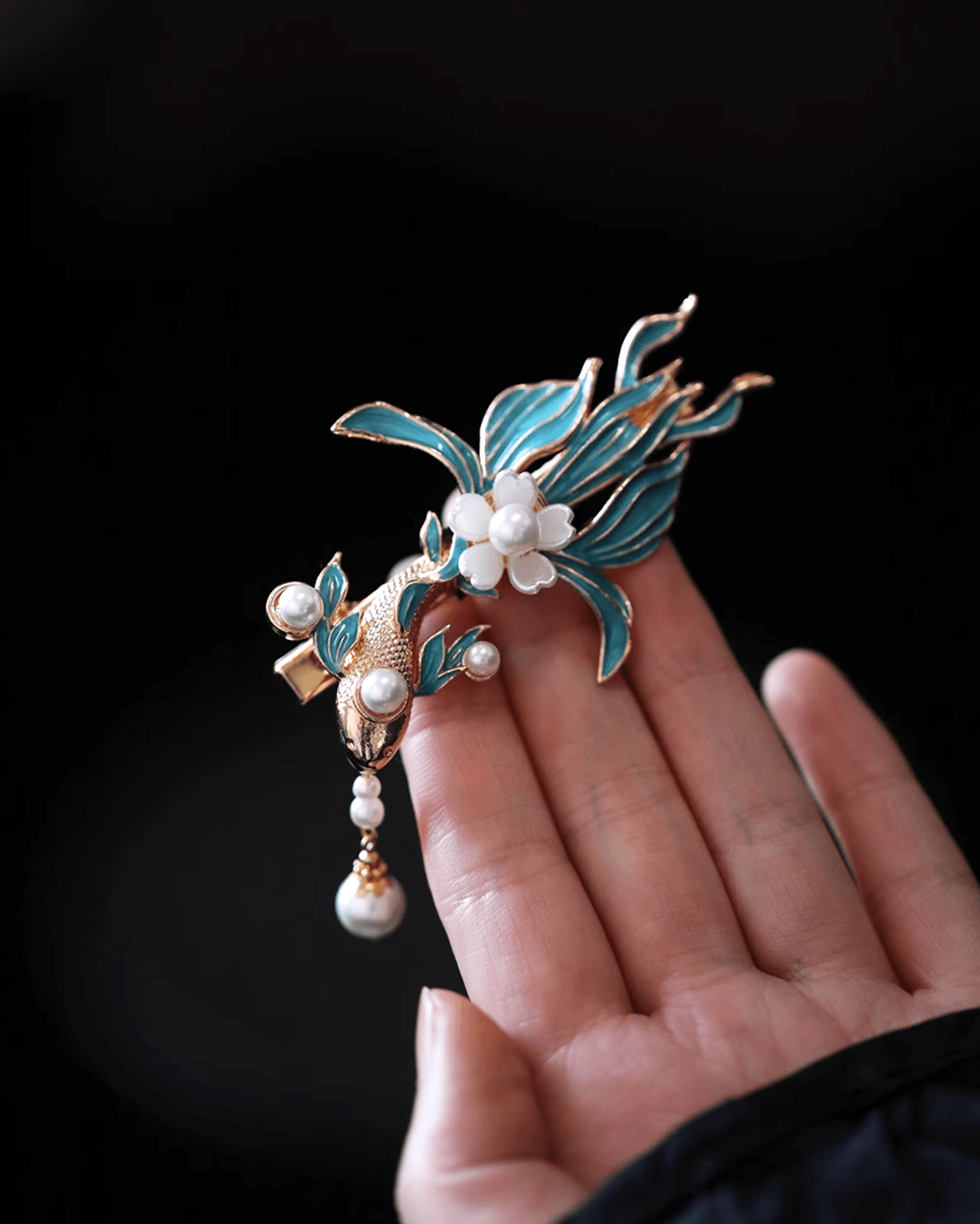 Close-up of cloisonné enamel koi motif with gold-tone finish, symbolizing luck and transformation