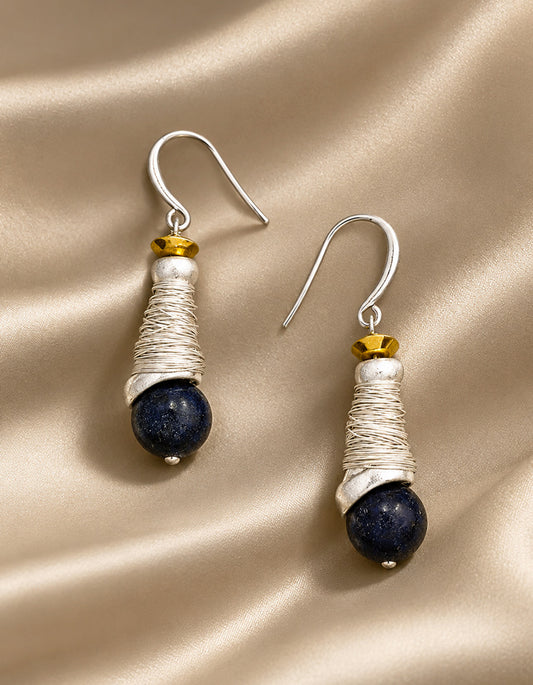 Detail of natural lapis lazuli stone glowing with deep celestial blue, set within hand-crafted silver spiral