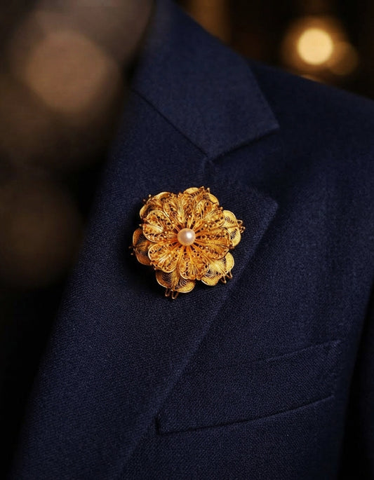 Model wearing a handcrafted Chinese filigree lotus brooch by ZolanJewelry, featuring delicate Huasi Xiangqian metalwork and a natural pearl.