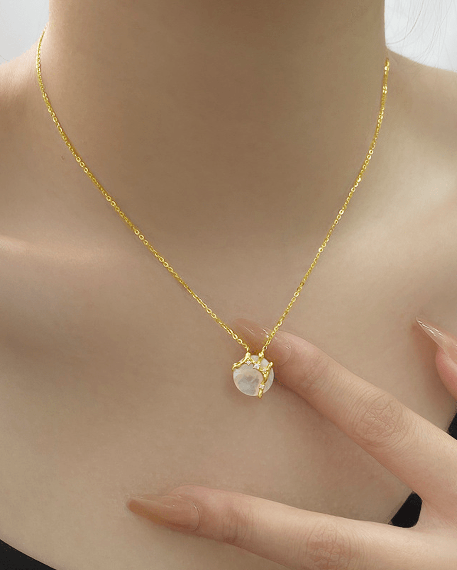 Elegant evening look featuring moon necklace paired with black-tie dress, highlighting celestial shimmer