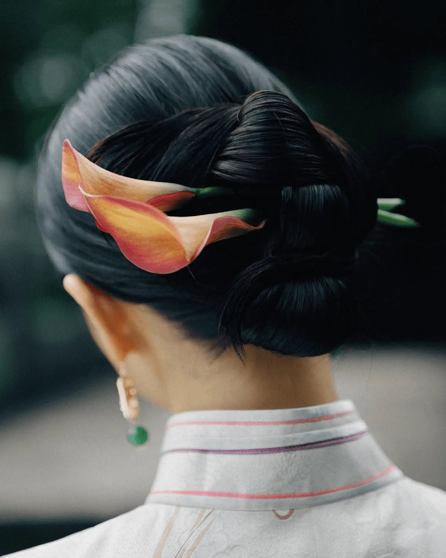 Close-up of featherlight earring curve and soft color gradient on ear