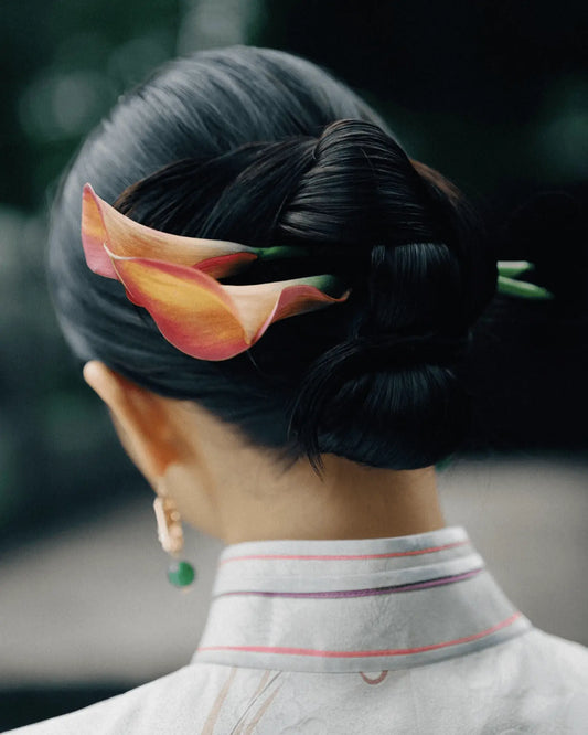 Close-up of featherlight earring curve and soft color gradient on ear