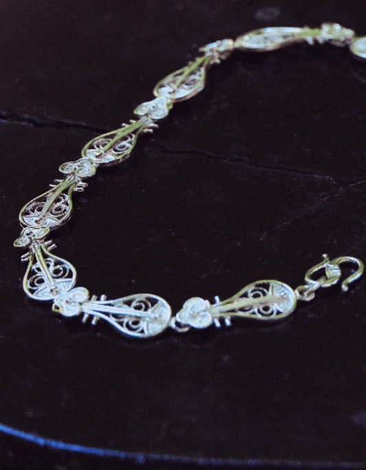 Close-up of zolanjewelry handcrafted dunhuang motif Pipa-shaped silver bracelet with fine Chinese filigree wirework