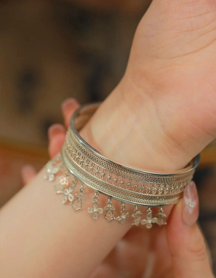 Close-up of a pure silver filigree tassel bracelet, showcasing hand-twisted silver wires and delicate tassel craftsmanship