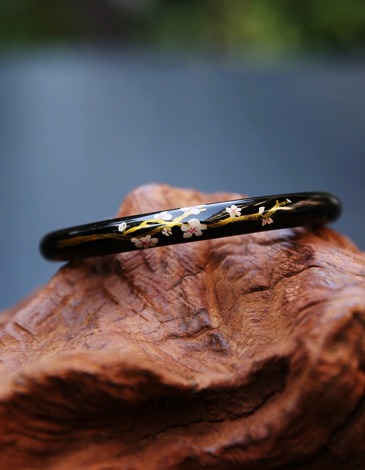 Handcrafted sakura-inspired bracelet with traditional Chinese gilded lacquer and soft pink floral motifs