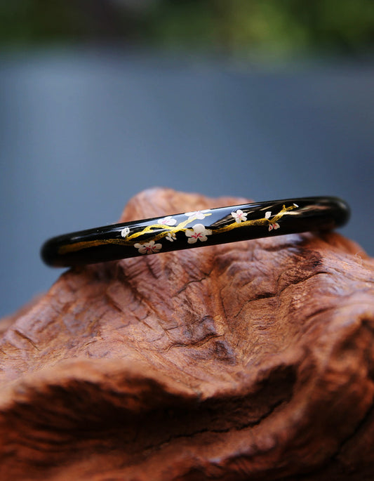 Handcrafted sakura-inspired bracelet with traditional Chinese gilded lacquer and soft pink floral motifs