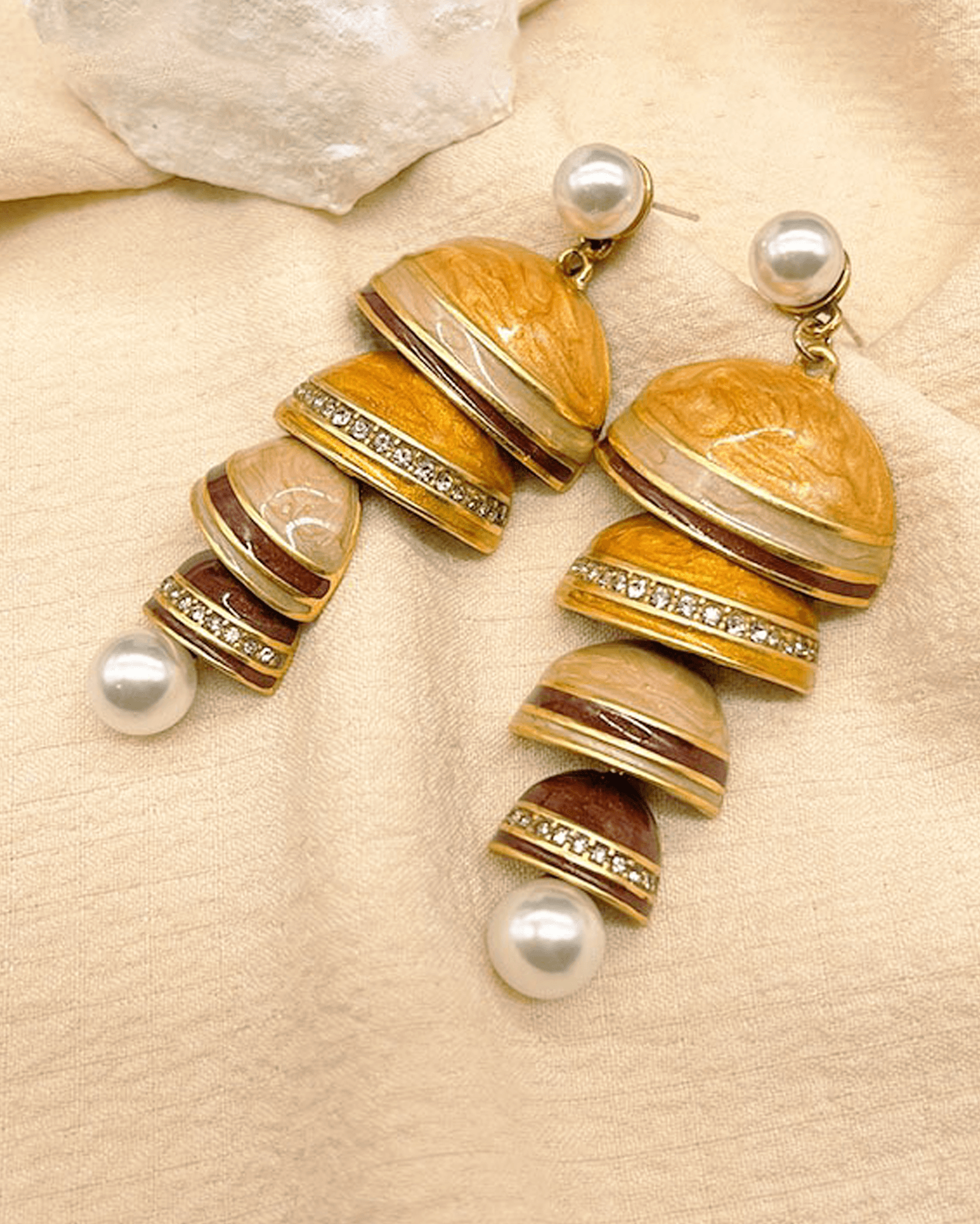 Flat lay of cloisonné pearl earrings with Tibetan-inspired silver chimes and mother-of-pearl beads, reflecting Song Dynasty aesthetics