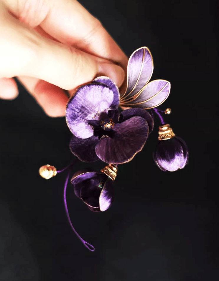 Elegant Vanda ‘Miss Joaquim’ Orchid brooch styled on a business suit, showcasing regal purple lacquer and heritage velvet craftsmanship