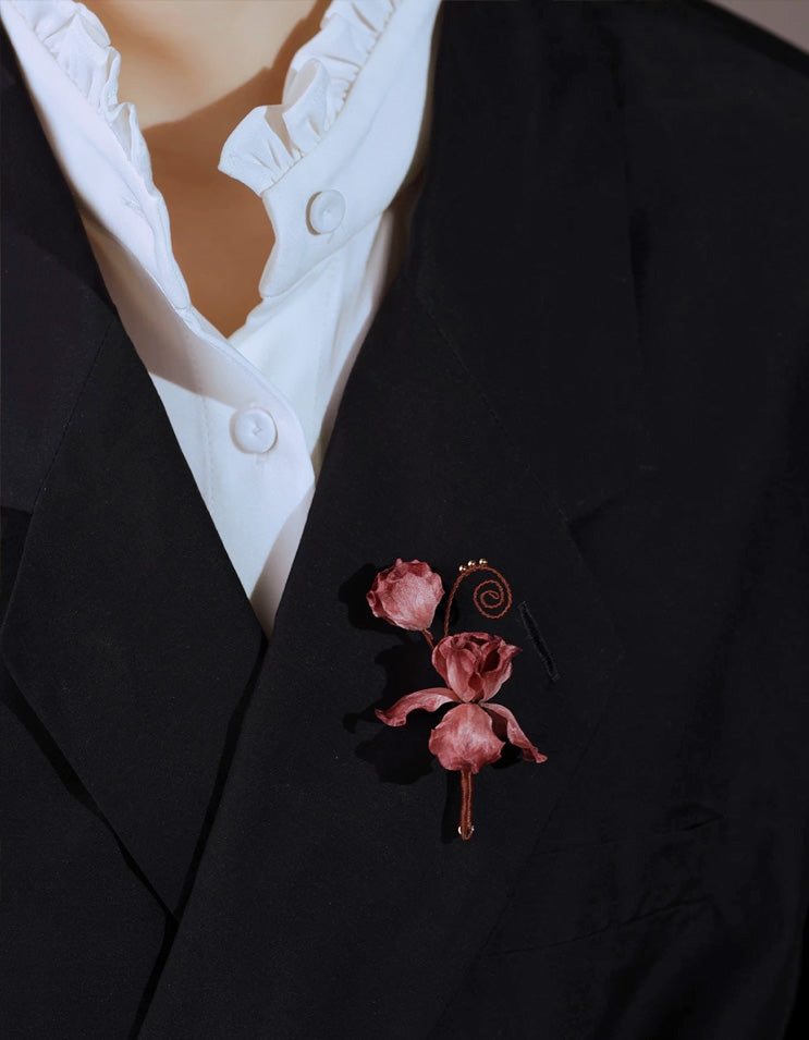 Handmade velvet flower brooch worn on a tailored suit lapel, showcasing elegant Chinese ronghua craftsmanship